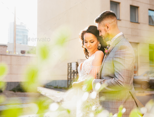 Caucasian romantic young couple celebrating their marriage in city - Stock Photo - Images