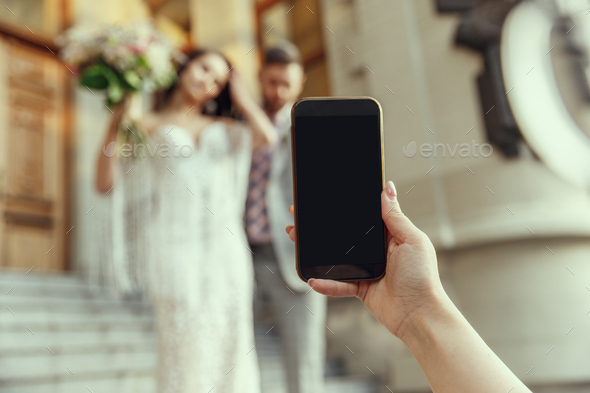 Caucasian romantic young bride celebrating his marriage in city - Stock Photo - Images