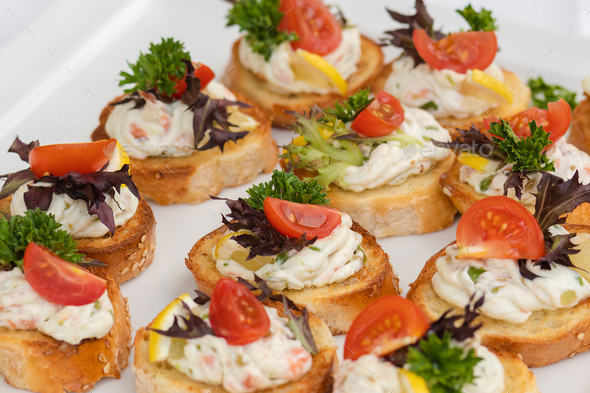 Closeup of delicious canape served on white plate - Stock Photo - Images