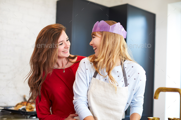 Gay Female Couple At Home In Kitchen Washing Up After Dinner On Christmas Day