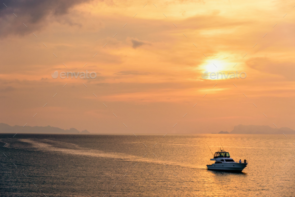 Speedboat returning during the sunset - Stock Photo - Images