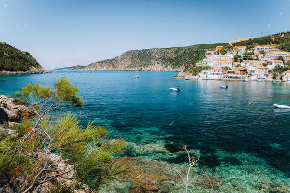 Turquoise transparent lagoon surrounded by green pine trees. Assos village, Kefalonia Greece. Blue - Stock Photo - Images