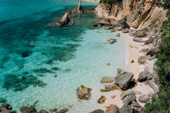 Hidden empty beach with pure clear turquoise sea water near white rock cliffs located in famous - Stock Photo - Images