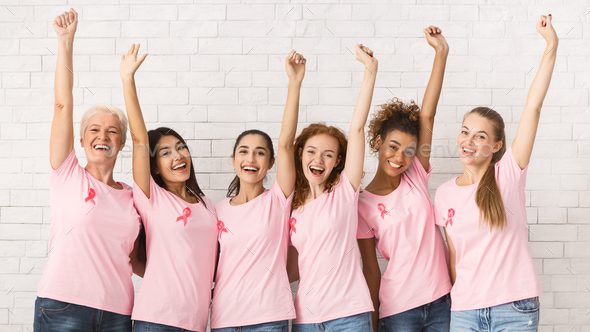 Breast Cancer Volunteers Raising Hands Supporting Awareness Campaign Indoor - Stock Photo - Images