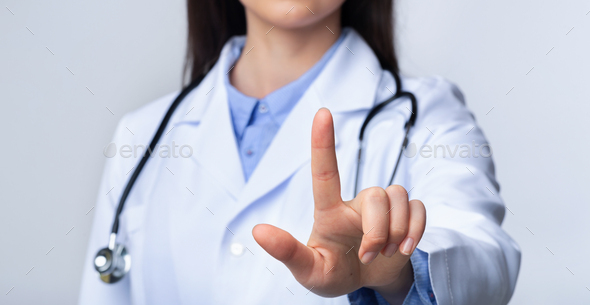 Unrecognizable Doctor Woman Pressing Key On Invisible Touchscreen, White Background - Stock Photo - Images