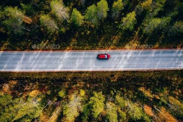 Aerial view of road in beautiful autumn forest in rural Finland. - Stock Photo - Images