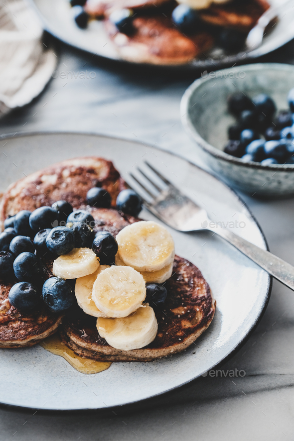 Banana pancakes with bluelerry and honey over marble table - Stock Photo - Images