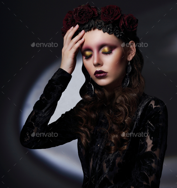 Woman with theatrical makeup in spotlight