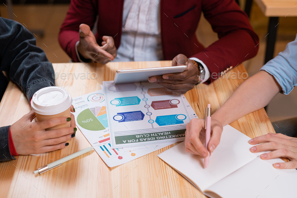 Contemporary young African businessman pointing at touchpad display - Stock Photo - Images