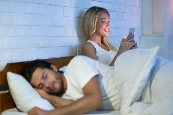 Cheating Wife Chatting On Cellphone While Husband Sleeping In Bedroom