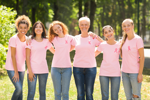 Multiethnic Ladies In T-Shirts With Pink Ribbons Embracing In Park