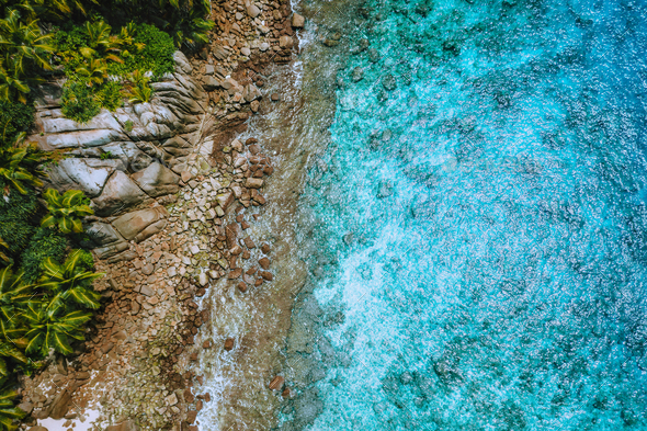 Aerial drone view of tropical coastline, crystal clear turquoise ocean water, bizarre granite rocks - Stock Photo - Images