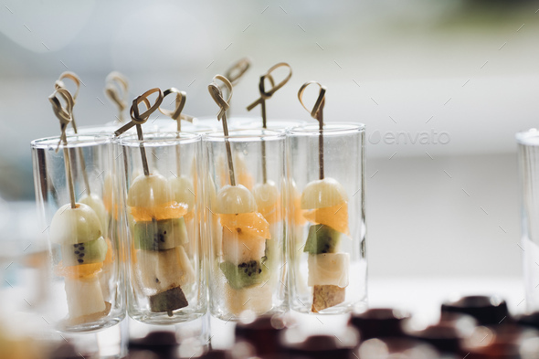 Delicious healthy fruit appetizers on celebration Concept of catering, desserts, arrangement and - Stock Photo - Images