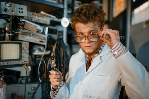 Strange engineer holds electric tube in laboratory