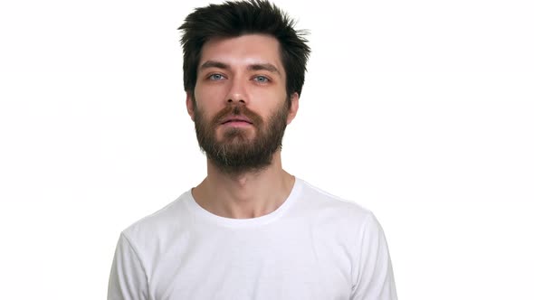 Young Relaxed Male Making Friendly Greeting Gestures on White Background alt