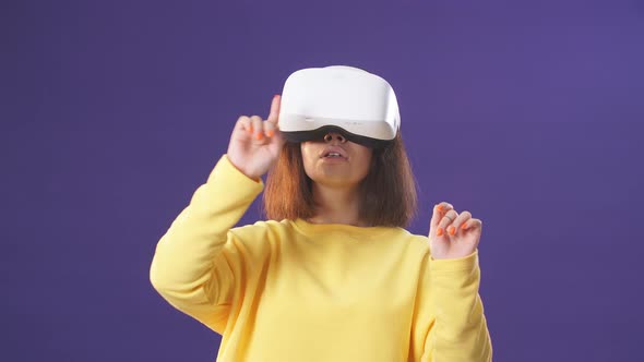 Woman Uses a Virtual Reality Glasses Indoors alt