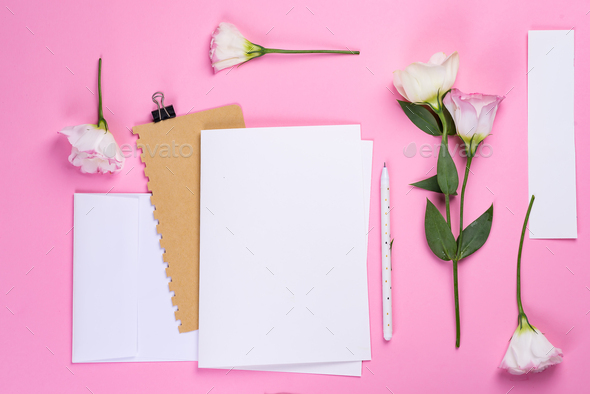 Flowers composition. Paper blank and notebook with eustoma pink flowers on pink background. Flat lay - Stock Photo - Images