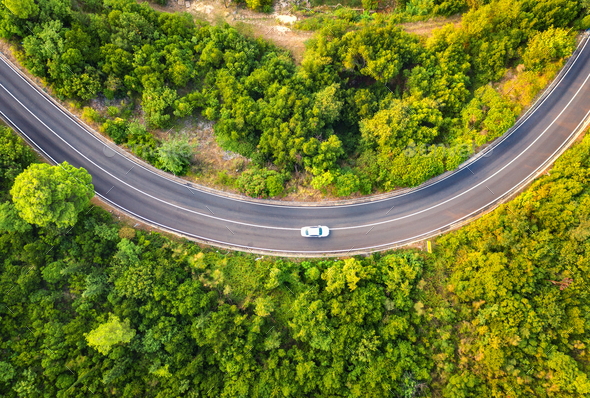 Aerial view of road with car in beautiful forest in summer - Stock Photo - Images