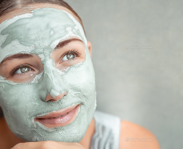 Beautiful girl doing facial mask - Stock Photo - Images