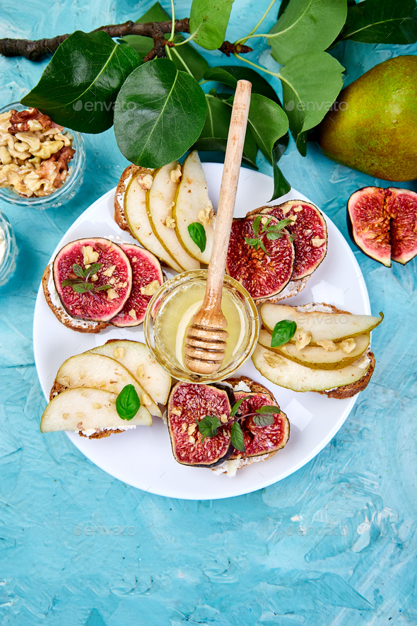 Bruschetta and Crostini with pear, ricotta cheese, honey, figs. - Stock Photo - Images