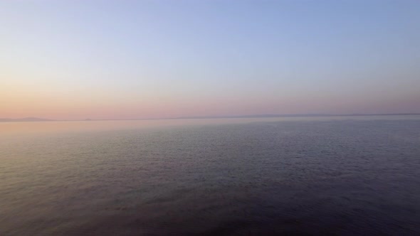 Aerial Evening View of Vast Sea, Lonely Boat and Skyline alt