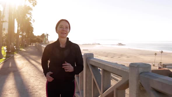 Mature Woman Exercising At The  Beach alt