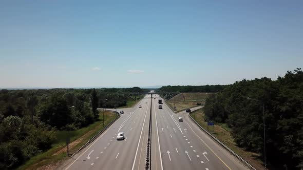 Fly Over Highway Road Junction in the Countryside with Trees and Cultivated Fields alt