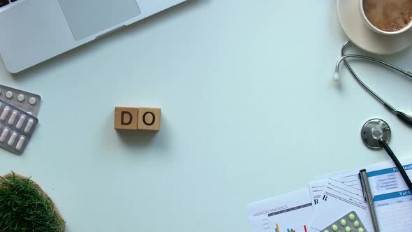 Doctor Word Made of Wooden Cubes Top View, High Quality Medical Care Services alt