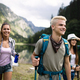 Group of young friends hiking in countryside. Multiracial happy people  travelling in nature Stock Photo