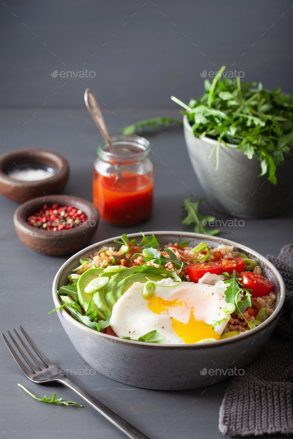 quinoa bowl with fried egg, avocado, tomato, rocket. Healthy veg