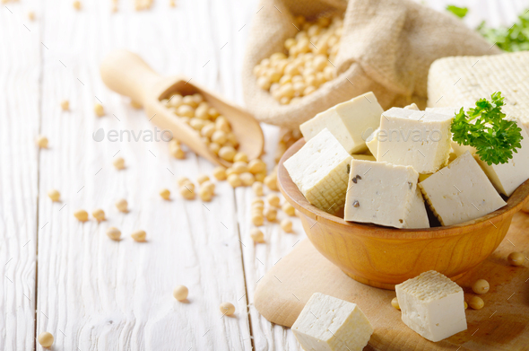 Soy Bean curd tofu in wooden bowl and in hemp sack on white wood - Stock Photo - Images