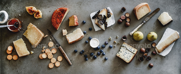 Variety of wine snacks, jam and cheeses over grey background - Stock Photo - Images