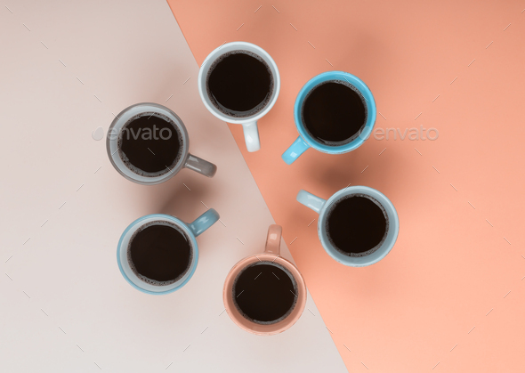 Coffee in the different cups on the coral background. Flatlay, cheerful day concept - Stock Photo - Images