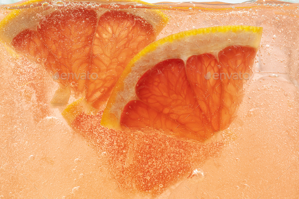 Close up view of the lemon and grapefruit slices in lemonade on background - Stock Photo - Images