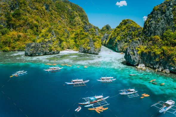 Aerial view of tourist boats in front of big Lagoon at Miniloc Island, El Nido, Palawan, Philippines - Stock Photo - Images