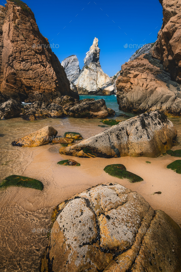 Ursa beach, Sintra, Portugal. Epic seascape with sharp cliffs rising from the turquoise sea waters - Stock Photo - Images