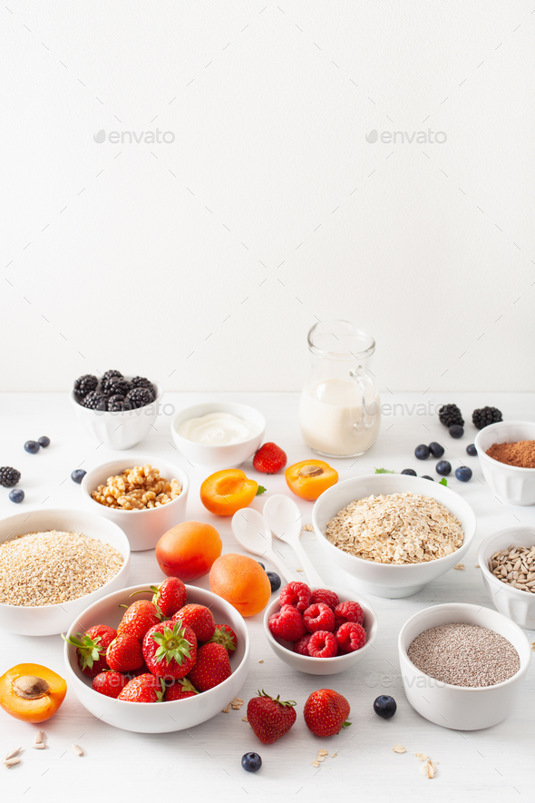 variaty of raw cereals, fruits and nuts for breakfast. Oatmeal f - Stock Photo - Images