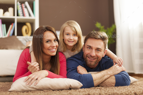 Portrait of loving family on carpet - Stock Photo - Images