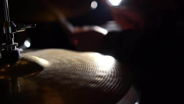 Hands of musician drummer holding drum sticks hitting on hi-hat cymbal