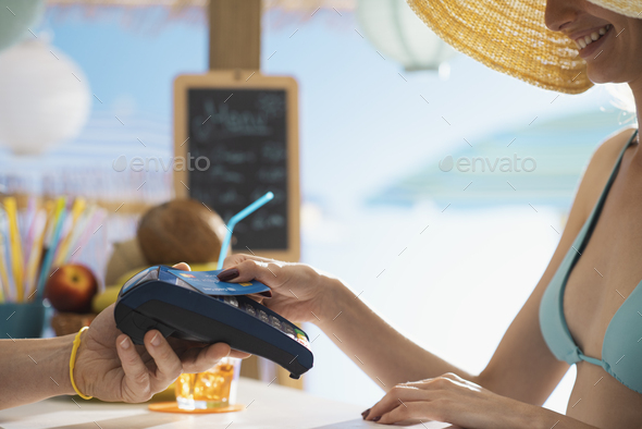 Woman paying using a contactless credit card - Stock Photo - Images