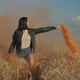 Joyful Asian Woman with Colored Smoke Bomb Outdoors - VideoHive Item for Sale