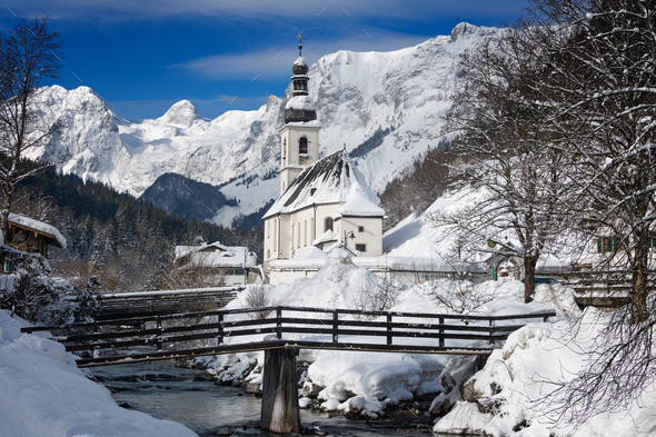 Ramsau church with Alps mountains in the snow in winter - Stock Photo - Images