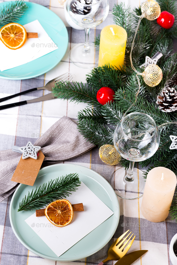 Festive Christmas and New Year table setting with dry orange and cinnamon on a gray textile. Dining - Stock Photo - Images