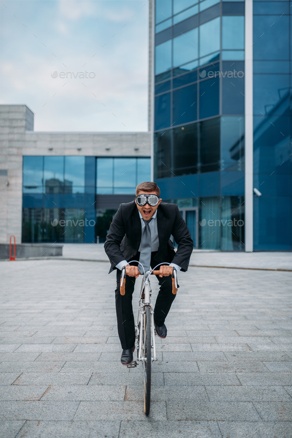 One businessman in funny glasses poses on bicycle - Stock Photo - Images