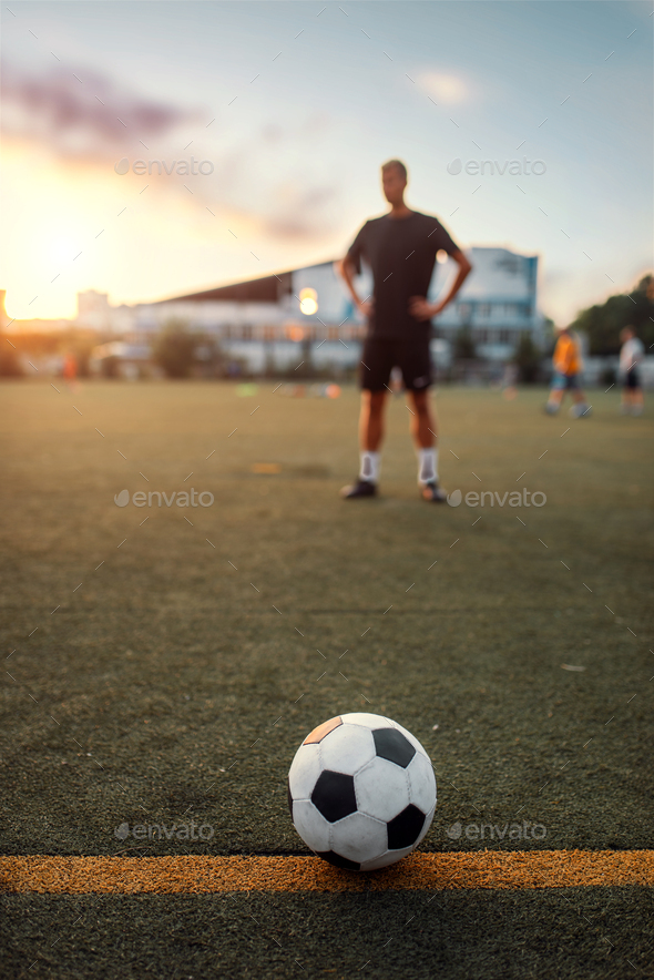 Soccer ball on line, player on background - Stock Photo - Images