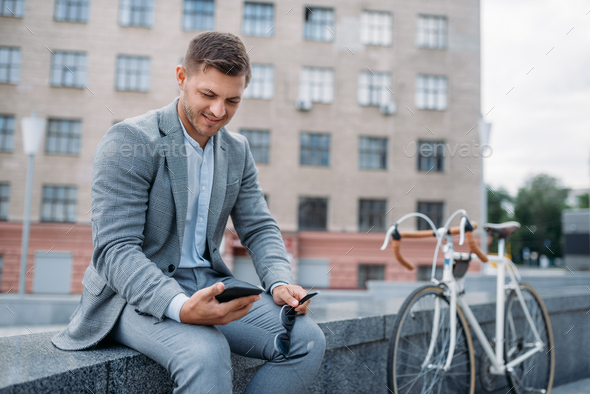 One businessman with cycle at office building - Stock Photo - Images