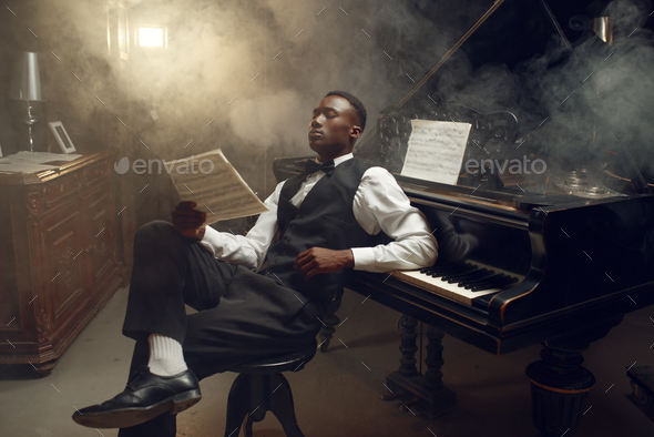 Ebony pianist with music notebook, jazz musician