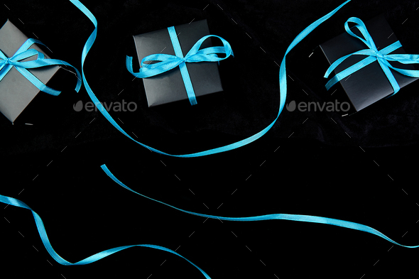Luxury black gift boxes with blue ribbon - Stock Photo - Images