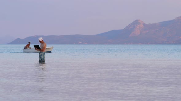 Hipster with Notebook on Sunset Background. Freelancer Working on the Nature. Distant Job Background alt
