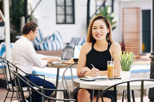 Beautiful businesswoman at cafe table - Stock Photo - Images